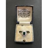 A Diamond and Emerald 18 carat gold ring, (2.8 grams). An attractive setting