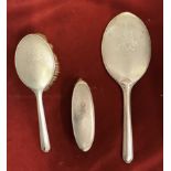 C. & G. Co., Ladies silver dressing table accessories, three pieces including two brushes and a hand