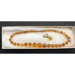 An Amber Coloured Glass Round bead necklace with clear glass spacers, gold plated bolt ring