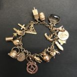 A 9 carat gold trace chain Charm Bracelet with 23 charms several interesting including Masonic,