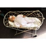 Vintage dolls cradle/basket on castors, metal frame with string sides, height 17.5 inches, length