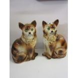 EDWARDIAN STAFFORDSHIRE POTTERY, pair of seated and gilded Cats, inset glass eyes, 12" height