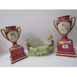 VIENNA-STYLE VASES, pair of cerise ground plinth base 9.5" vases, decorated with putti; also