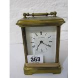 CARRIAGE CLOCK, a brass cased carriage clock with dial signed Lesley P Dembo (1 panel loose)