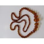 GRADUATED AMBER NECKLACE, large string of multi facetted amber beads, approx 80 grams and approx 42"