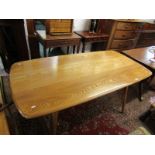 MID-CENTURY, Blonde Ercol rectangular dining table on splayed legs, 148 cm x 75 cm