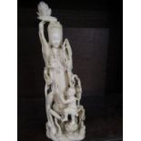 ANTIQUE EASTERN IVORY, a fine carved ivory 24cm sculpture of Lotus Goddess with Boy playing at base