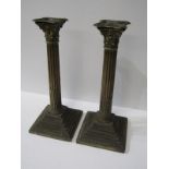 PAIR OF SILVER CORINTHIAN COLUMN CANDLESTICKS, on square form stemmed bases, 30cm height with filled