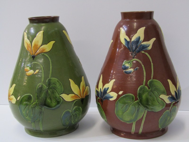 CONTINENTAL POTTERY, 2 slip glaze 20cm vases decorated with relief cyclamen