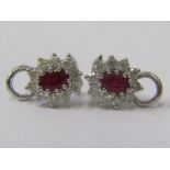 PAIR OF 18ct WHITE GOLD RUBY & DIAMOND CLIP ON EARRINGS, principal oval cut rubies surrounded by