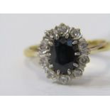 18ct YELLOW GOLD SAPPHIRE & DIAMOND CLUSTER RING, principal oval cut sapphire surrounded by