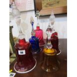ANTIQUE GLASS, 4 cranberry glass table bells, 3 with ribbed glass handles and opaque glass rims,