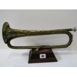 VINTAGE MILITARY MUSICAL INSTRUMENT, vintage military bugle by Henry Potter, 1891 on stand with