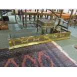 ANTIQUE METALWARE, an attractive pierced brass fire curb with embossed swag decoration, 129cm width