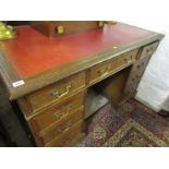 OAK KNEEHOLE DESK, twin pedestal oak kneehole desk of 9 graduated drawers with brass swan neck