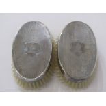 SILVER BACKED GENTS BRUSHES, pair of oval engine turned decorated brushes, indistinct assay marks