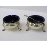 MID 18TH CENTURY SILVER SALTS, pair of circular bodied salts on 3 hoot feet with blue glass