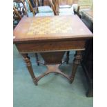 VICTORIAN WALNUT GAMES TABLE, marquetry base with tapering turned legs and stretchered shelf
