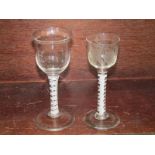 ANTIQUE GLASSWARE, 2 double series opaque twist stem glasses, one with engraved vine decoration,