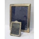 SILVER PHOTO FRAMES, rectangular 24cm plain framed easel photo frame, together with smaller ornate