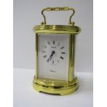 CARRIAGE CLOCK, oval brass cased bevelled glass carriage clock by Swiza with key, 13cm height