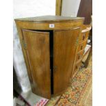 ANTIQUE CORNER CABINET, oak bow fronted twin door hanging corner cabinet with shaped brass hinges,