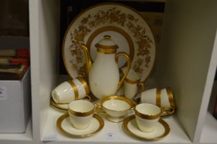 A Royal Doulton gilt decorated coffee service (AF) and a similar plate.