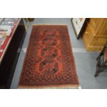 A Persian rug, red ground with four large medallions.