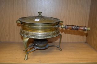 An Indian cooking pan with stand.