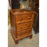 A pine bedside cupboard.