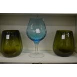 A pair of moulded green glass vases and a large brandy goblet.