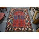 A Persian style carpet, red ground with geometric design.
