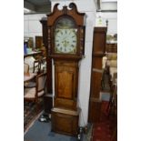 An 18th century oak and mahogany longcase clock with eight day movement, the painted arch dial