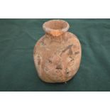 An old moulded terracotta vessel.