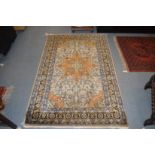 A Persian rug, beige ground with floral decoration.