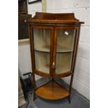 An Edwardian inlaid mahogany standing bow front corner cabinet.