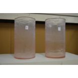 A pair of large frosted pink glass vases.