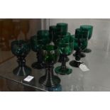 A group of 19th century and later green glass goblets.