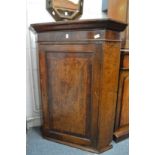 A 19th century oak and mahogany hanging corner cupboard.