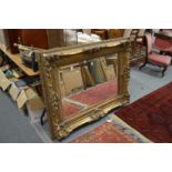 A large decorative gilt framed mirror.