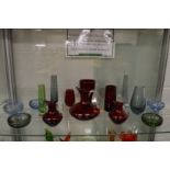 A small collection of stylish glassware to include ruby tinted glass jugs, vases and small bubble
