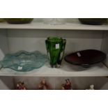 A heavy lobed green glass vase, a turquoise wavy rimmed dish and a ruby glass oval dish.