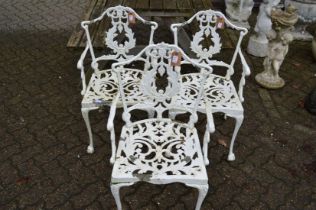 Three white painted aluminium garden armchairs.
