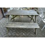 A pine picnic table with bench seat.