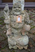 A garden ornament modelled as a Buddha.