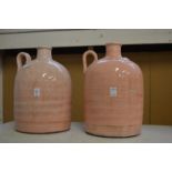 Two large pink glazed flagons.