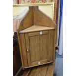 A pine hanging corner cupboard.