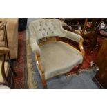 An upholstered horseshoe shaped open armchair.