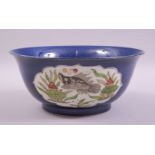 A CHINESE BLUE GLAZED PORCELAIN BOWL, decorated with panels of fish in the wucai palette amongst