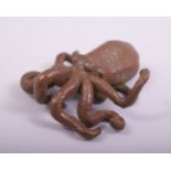 A JAPANESE BRONZE MODEL OF AN OCTOPUS, with large mark to underside, 7cm long.